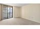 Well-lit bedroom with neutral carpeting and ample natural light from a large window at 1020 15Th St # 25D, Denver, CO 80202