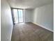 Sunny bedroom with carpet and balcony with expansive city views at 1020 15Th St # 25D, Denver, CO 80202