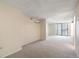 Neutral living room with plush carpeting, sliding glass doors to balcony, offering ample space and natural light at 1020 15Th St # 25D, Denver, CO 80202