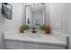Clean and modern powder room with a marble countertop, stylish mirror, and decorative plants at 2432 Ames St, Edgewater, CO 80214