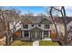 Charming two-story duplex with white siding, black trim, green accents, and a well-manicured front lawn at 2432 Ames St, Edgewater, CO 80214