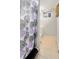 Bathroom with white vanity, beige tile, and decorative shower curtain at 11367 Fowler, Northglenn, CO 80233