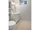 Half bath with white vanity and beige tile at 11367 Fowler, Northglenn, CO 80233