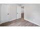Bedroom with light gray walls, wood-look flooring, and white trim and doors at 11367 Fowler, Northglenn, CO 80233