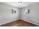 Bedroom with two windows, and dark wood-look flooring at 11367 Fowler, Northglenn, CO 80233