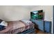 Cozy bedroom with comfortable bed, side dresser and a large screen TV on the dresser at 11367 Fowler, Northglenn, CO 80233