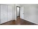 Bedroom with double closet doors and dark wood-look flooring at 11367 Fowler, Northglenn, CO 80233