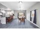 Bright dining area with a view into the modern kitchen featuring an island and breakfast bar at 11367 Fowler, Northglenn, CO 80233