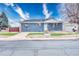 Classic blue brick house with manicured front yard, concrete driveway, and separate garage at 11367 Fowler, Northglenn, CO 80233