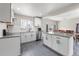Modern kitchen with white cabinets, stainless steel appliances, granite countertops, and an island at 11367 Fowler, Northglenn, CO 80233