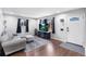 Inviting living area with hardwood floors, a plush couch, and a view of the front entrance at 11367 Fowler, Northglenn, CO 80233