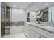 This bathroom has a walk-in shower, soaking tub, and double sink with marble countertop at 10226 E Fair Pl, Englewood, CO 80111