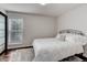 Cozy bedroom featuring a queen bed, neutral colors, and a light-filled window at 10226 E Fair Pl, Englewood, CO 80111