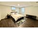 Bedroom with two windows, a neutral color scheme, laminate flooring, and a queen bed at 10226 E Fair Pl, Englewood, CO 80111