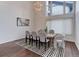 An elegant dining room with wood floors, a unique chandelier, and modern decor at 10226 E Fair Pl, Englewood, CO 80111