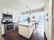 Modern kitchen with stainless steel appliances, white cabinets, and granite countertops at 10226 E Fair Pl, Englewood, CO 80111