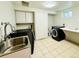 This laundry room has a utility sink, washer, dryer, and counter space at 10226 E Fair Pl, Englewood, CO 80111