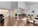 Open-concept space featuring hardwood floors, fireplace, piano, and seamless transition to the dining area at 10226 E Fair Pl, Englewood, CO 80111