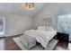 Inviting main bedroom featuring a vaulted ceiling, a queen bed, and hardwood floors at 10226 E Fair Pl, Englewood, CO 80111