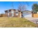 Charming two-story home with a brick and vinyl exterior, a well-manicured lawn, and an attached two-car garage at 15876 E Flora Pl, Aurora, CO 80013