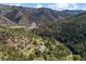 Scenic aerial view showcasing the home's location amidst mountains and greenery at 55 Two Moon Rd, Idaho Springs, CO 80452