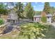 Expansive backyard with stone retaining wall, built-in shelving, and spacious lawn at 55 Two Moon Rd, Idaho Springs, CO 80452