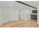 Basement featuring wood-look flooring, a wood beam, and a fireplace with a stone surround at 55 Two Moon Rd, Idaho Springs, CO 80452