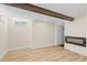 Basement featuring wood-look flooring, a modern fireplace, white walls, and a window at 55 Two Moon Rd, Idaho Springs, CO 80452