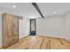 Basement featuring wood-look flooring, a wood beam, a closet, and an exterior door at 55 Two Moon Rd, Idaho Springs, CO 80452