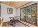 Bright dining area featuring a wooden table, chairs, and a scenic view from the window at 55 Two Moon Rd, Idaho Springs, CO 80452