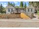 Inviting home showcasing a stone wall, deck and steps, offering great curb appeal at 55 Two Moon Rd, Idaho Springs, CO 80452