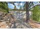 Garage exterior featuring a stone retaining wall and a driveway at 55 Two Moon Rd, Idaho Springs, CO 80452