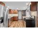 Well-lit kitchen featuring stainless steel appliances, granite countertops, and warm wood cabinetry at 55 Two Moon Rd, Idaho Springs, CO 80452