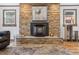Living room with a stone fireplace, a black fireplace insert, and a picture of a deer above the fireplace at 55 Two Moon Rd, Idaho Springs, CO 80452