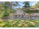 Close up view of the stone retaining wall with built in shelving in the backyard at 55 Two Moon Rd, Idaho Springs, CO 80452
