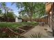 Charming backyard featuring garden beds, shed, patio seating, and a wooden fence for privacy at 1245 Garfield St, Denver, CO 80206