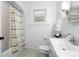 Clean, renovated bathroom features green patterned floors, white subway tile in shower, and wainscoting at 1245 Garfield St, Denver, CO 80206