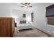 Cozy bedroom with ceiling fan, plush rug, and natural light from two windows at 1245 Garfield St, Denver, CO 80206