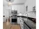 Modern kitchen featuring stainless steel appliances, granite countertops, and white cabinetry at 1245 Garfield St, Denver, CO 80206