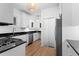 Modern kitchen featuring white cabinets, granite countertops, stainless steel appliances, and hardwood floors at 1245 Garfield St, Denver, CO 80206