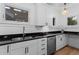 Bright kitchen with stainless steel appliances, granite countertops, and white cabinets at 1245 Garfield St, Denver, CO 80206