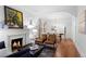 Inviting living room featuring a fireplace, hardwood floors, and an open layout leading to the dining area at 1245 Garfield St, Denver, CO 80206