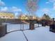 Fenced backyard with snow-covered patio and nice views at 10020 Strathfield Ln, Highlands Ranch, CO 80126