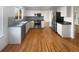 Modern kitchen with stainless steel appliances, white cabinets, and hardwood floors throughout the space at 10020 Strathfield Ln, Highlands Ranch, CO 80126