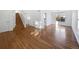 Bright living room with gleaming hardwood floors and staircase leading to the second floor at 10020 Strathfield Ln, Highlands Ranch, CO 80126