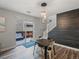 Cozy dining area with stylish lighting and stairs nearby, seamlessly connecting to an outdoor patio for relaxed living at 14823 W 70Th Dr # A, Arvada, CO 80007