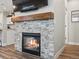Cozy fireplace with stone surround, wood mantel, and a mounted television above it at 14823 W 70Th Dr # A, Arvada, CO 80007