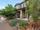 Two-story home with stone and siding facade, front porch, and landscaped yard at 14823 W 70Th Dr # A, Arvada, CO 80007