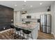 Modern kitchen featuring granite countertops, stainless steel appliances, and a stylish backsplash, blending functionality with elegance at 14823 W 70Th Dr # A, Arvada, CO 80007