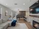 Open-concept living space with a fireplace, sofa, and dining area; perfect for entertaining and modern living at 14823 W 70Th Dr # A, Arvada, CO 80007